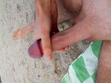 Gay wanks his huge dick and cums at the beach in public